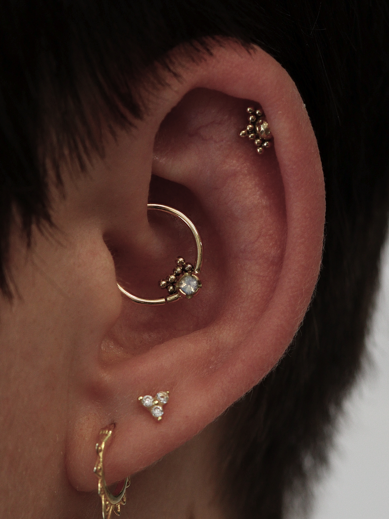 Daith & Helix piercings with bespoke 18k gold jewellery from Ixus fine jewellery